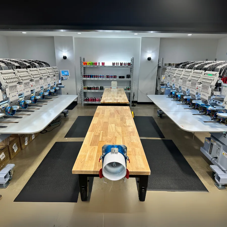 Commercial multi-head embroidery machines inside the Satellite PrintLab production facility in Austin