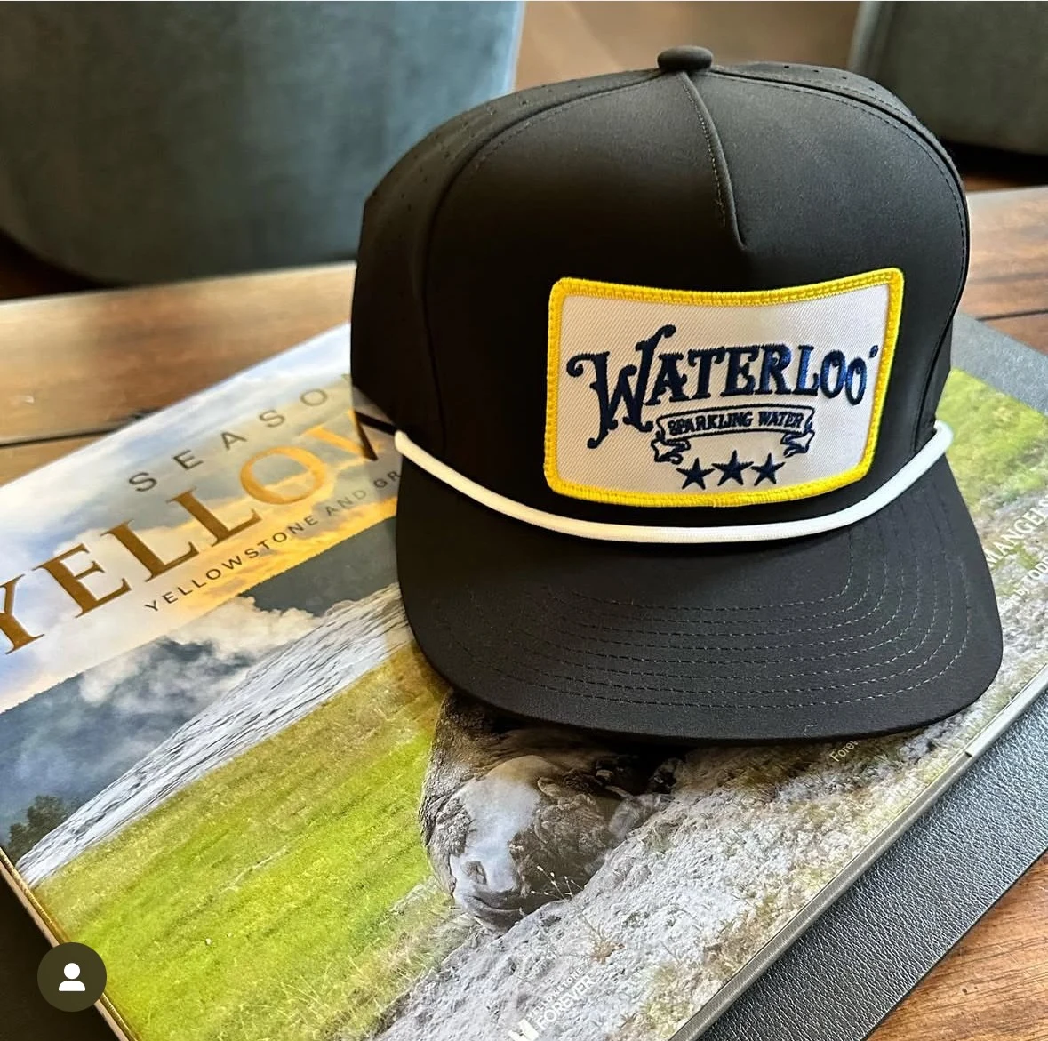 Black Waterloo Sparkling Water hat with a yellow bordered embroidered patch
