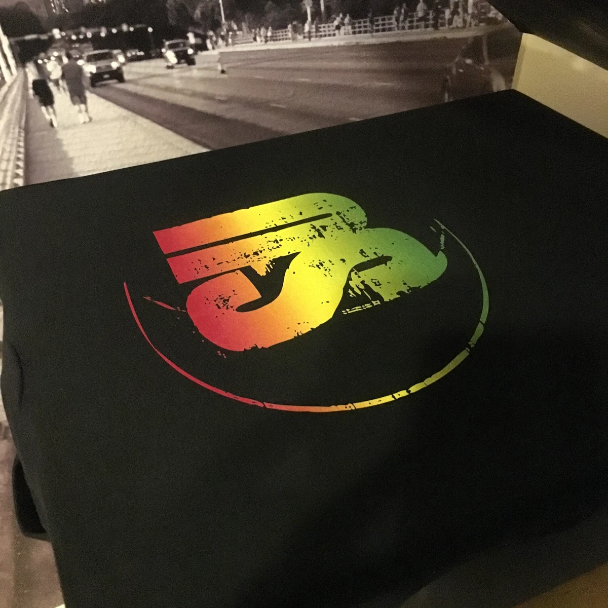Full-color custom printed black shirt produced by Satellite PrintLab